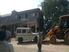 Woman Sarpanch climbs on JCB machine during an encroachment drive in Jalore 