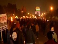 Masked protesters take out torchlight march against JNU case
