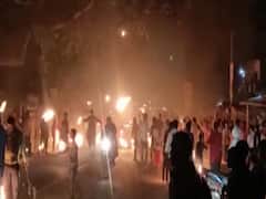 People celebrating Holi with fire instead of colors