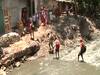 Mumbai: Migrant labourers cross dirty canals in a bid to return home
