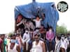 Police Taking Action Against Migrant Workers Travelling Back Home In Trucks | ABP Uncut