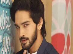 Harsh Rajput's mother helps him cook at his home in Gujarat