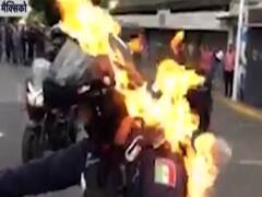 Protesters in Mexico set police officer on fire
