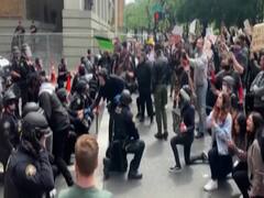 American policemen kneel before raging protesters to apologise