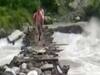 Uttarakhand: People risk lives as they cross rough bridge over flooded river