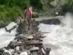Uttarakhand: People risk lives as they cross rough bridge over flooded river