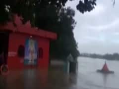 Man holds temple top tightly after slipping in swollen river, rescued later