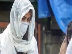 Rhea Chakraborty covers face, evades media and appears before ED