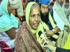 Elderly women sitting in protest alongside agitating farmers
